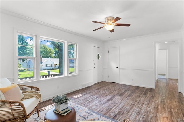 5706 Beverly Ave, Mission, KS 66202 - sitting room featuring wood finished floors, ceiling fan, and crown molding