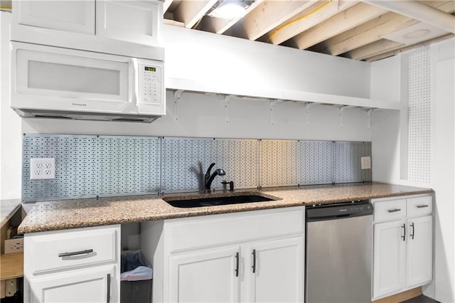 5706 Beverly Ave, Mission, KS 66202 - kitchen featuring stainless steel dishwasher, white microwave, and white cabinets