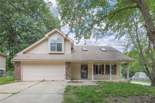 18120 E 25th Ter, Independence, MO 64057 - view of front of house with concrete driveway, a porch, a shingled roof, brick siding, and a garage