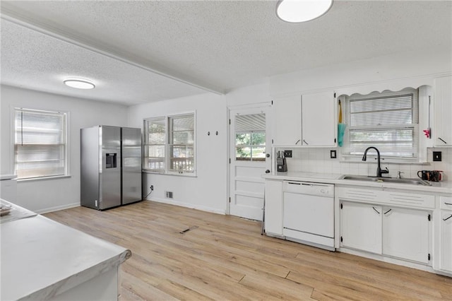 2206 N 73rd Ter, Kansas City, KS 66109 - kitchen featuring stainless steel fridge, white dishwasher, a textured ceiling, white cabinets, and light countertops