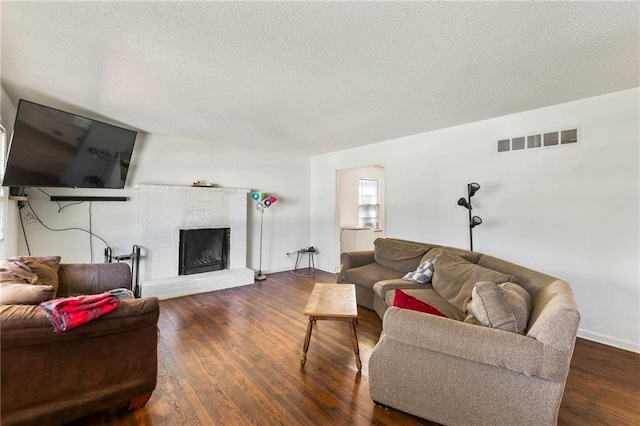 2206 N 73rd Ter, Kansas City, KS 66109 - living room featuring a textured ceiling, wood finished floors, and a fireplace