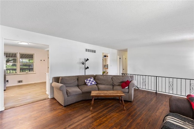 2206 N 73rd Ter, Kansas City, KS 66109 - living area with wood finished floors and a textured ceiling