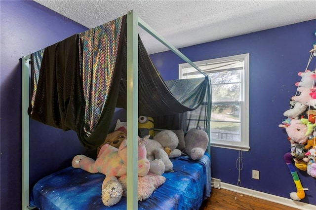 2206 N 73rd Ter, Kansas City, KS 66109 - bedroom featuring wood finished floors and a textured ceiling