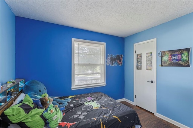 2206 N 73rd Ter, Kansas City, KS 66109 - bedroom featuring dark wood finished floors and a textured ceiling