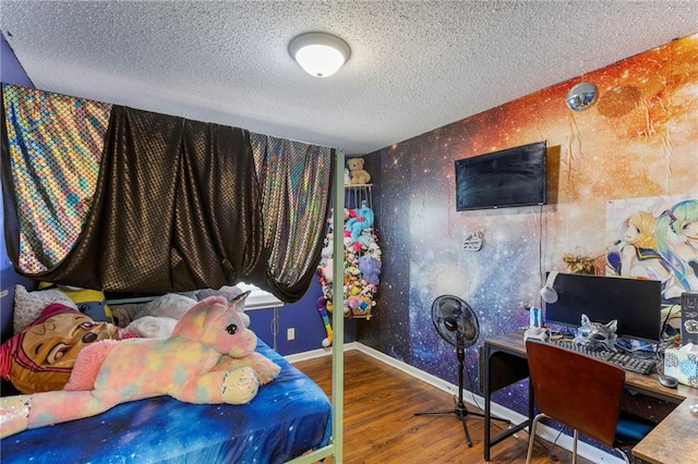 2206 N 73rd Ter, Kansas City, KS 66109 - bedroom with wood finished floors, a textured ceiling, a desk, and wallpapered walls