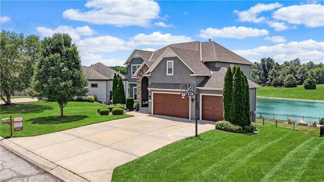 1216 Hillmann Ln, Warrensburg, MO 64093 - view of front of property with driveway, stucco siding, a garage, a water view, and roof with shingles
