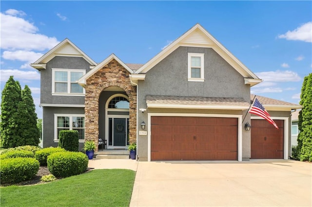 1216 Hillmann Ln, Warrensburg, MO 64093 - view of front of home featuring stucco siding, driveway, stone siding, a front yard, and an attached garage