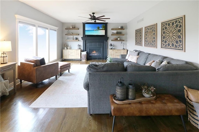 1216 Hillmann Ln, Warrensburg, MO 64093 - living room with a ceiling fan, dark wood-type flooring, and a glass covered fireplace