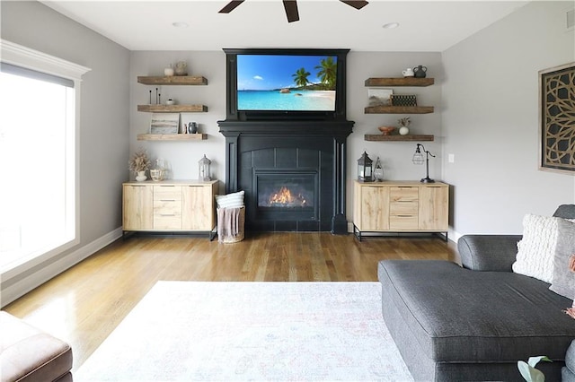 1216 Hillmann Ln, Warrensburg, MO 64093 - living area with ceiling fan, wood finished floors, and a tiled fireplace