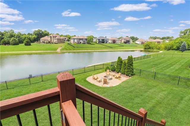 1216 Hillmann Ln, Warrensburg, MO 64093 - fenced backyard featuring a water view, an outdoor fire pit, a residential view, and a patio