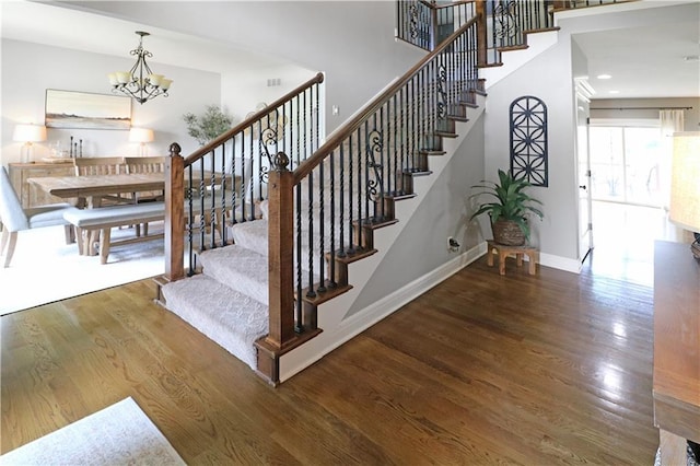 1216 Hillmann Ln, Warrensburg, MO 64093 - stairway featuring a chandelier and wood finished floors