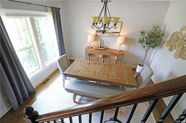1216 Hillmann Ln, Warrensburg, MO 64093 - dining area featuring plenty of natural light, wood finished floors, and a chandelier