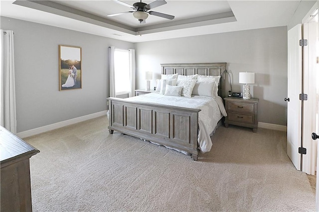 1216 Hillmann Ln, Warrensburg, MO 64093 - bedroom with a raised ceiling, light carpet, and a ceiling fan