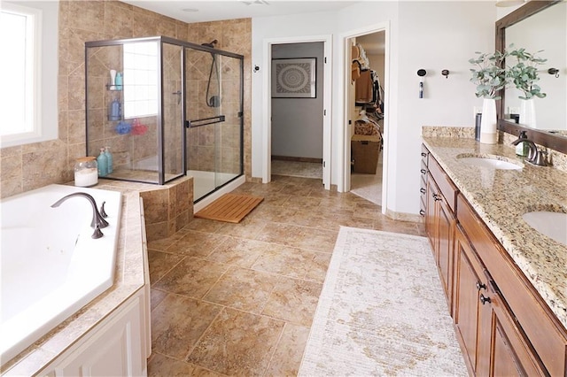 1216 Hillmann Ln, Warrensburg, MO 64093 - full bath featuring a shower stall, double vanity, a jetted tub, and a spacious closet
