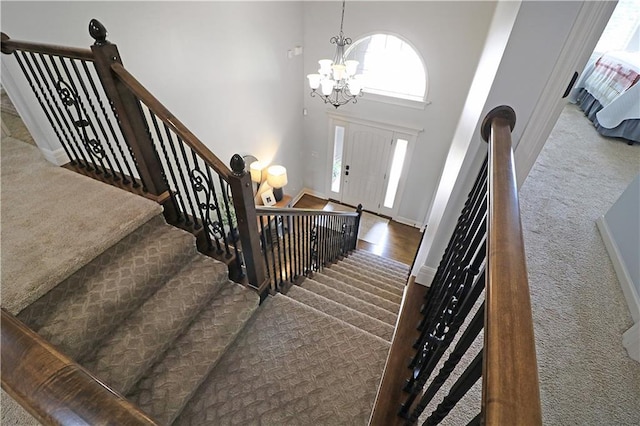 1216 Hillmann Ln, Warrensburg, MO 64093 - foyer featuring carpet floors, a chandelier, and a towering ceiling