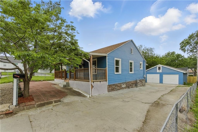 814 S Saville St, Independence, MO 64052 - bungalow-style home featuring a detached garage, an outdoor structure, and a porch
