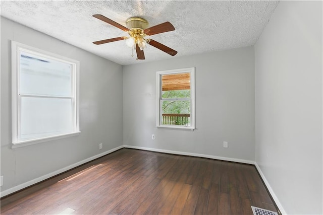 814 S Saville St, Independence, MO 64052 - empty room with wood finished floors, a textured ceiling, and a ceiling fan
