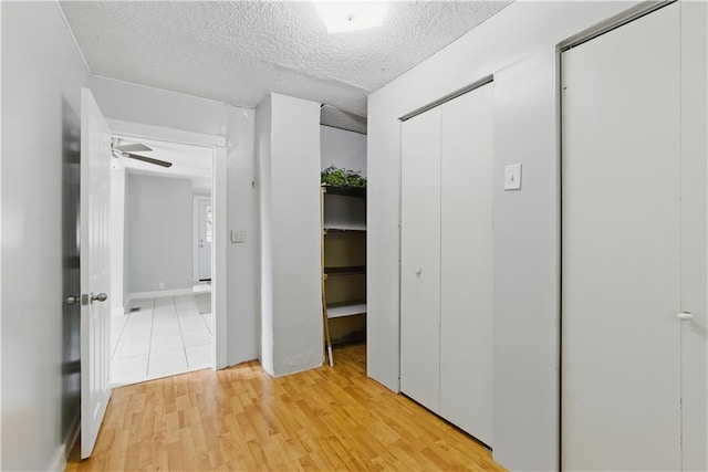 814 S Saville St, Independence, MO 64052 - unfurnished bedroom featuring a textured ceiling and light wood-style floors