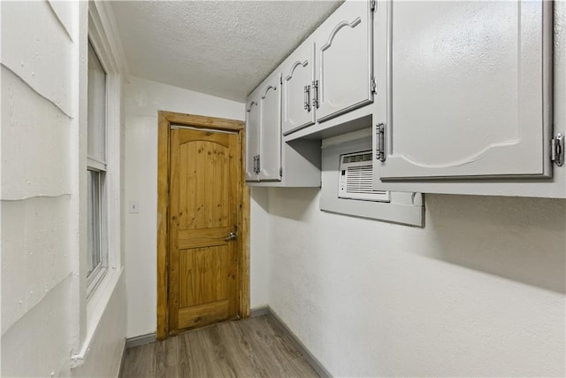 814 S Saville St, Independence, MO 64052 - entryway with wood finished floors and a textured ceiling