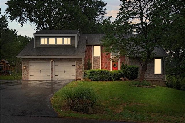 12343 Pinehurst Dr, Kansas City, KS 66109 - view of front of home with stone siding, asphalt driveway, a front yard, and a garage