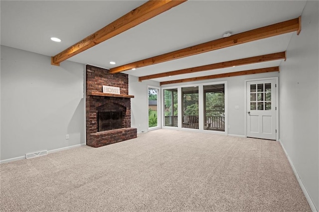 12343 Pinehurst Dr, Kansas City, KS 66109 - unfurnished living room featuring beamed ceiling, a brick fireplace, carpet flooring, and recessed lighting