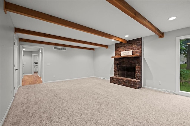 12343 Pinehurst Dr, Kansas City, KS 66109 - unfurnished living room with carpet, beamed ceiling, a fireplace, and recessed lighting