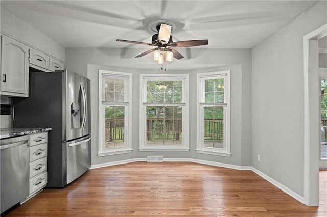 12343 Pinehurst Dr, Kansas City, KS 66109 - kitchen featuring appliances with stainless steel finishes, a ceiling fan, light wood-style floors, and white cabinets