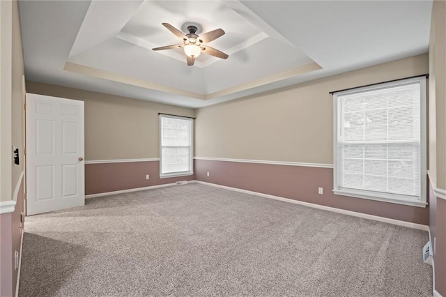 12343 Pinehurst Dr, Kansas City, KS 66109 - unfurnished room featuring a tray ceiling, a ceiling fan, and carpet floors