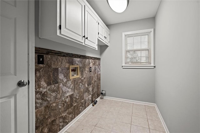 12343 Pinehurst Dr, Kansas City, KS 66109 - laundry area featuring washer hookup, light tile patterned flooring, and cabinet space