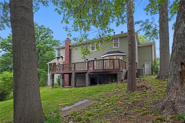 12343 Pinehurst Dr, Kansas City, KS 66109 - back of property featuring a wooden deck, a chimney, stairs, and a lawn