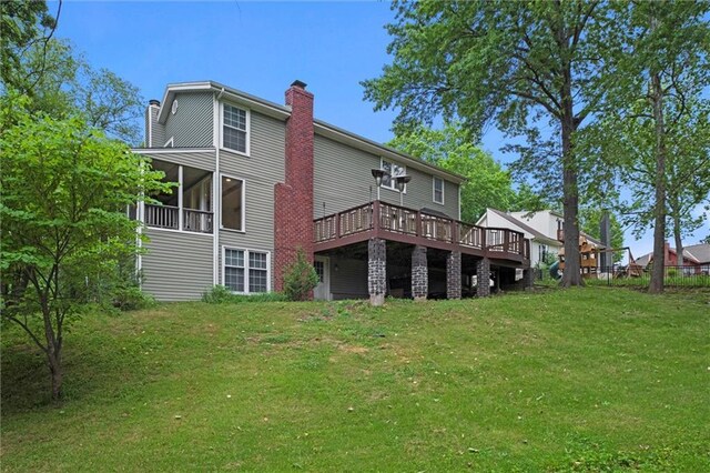12343 Pinehurst Dr, Kansas City, KS 66109 - rear view of property with a chimney, a yard, and a deck