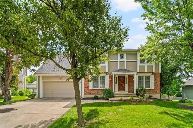 10601 Reeder St, Overland Park, KS 66214 - view of front of home with concrete driveway, an attached garage, a front lawn, and brick siding