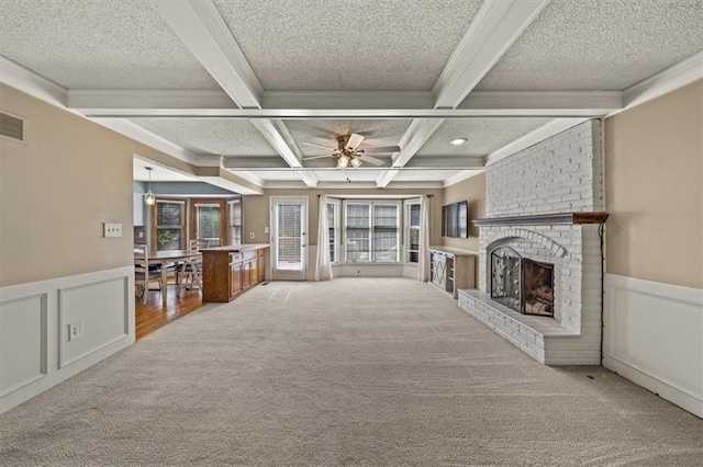 10601 Reeder St, Overland Park, KS 66214 - unfurnished living room featuring beamed ceiling, carpet flooring, coffered ceiling, a fireplace, and ceiling fan