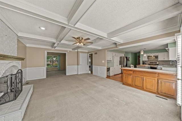 10601 Reeder St, Overland Park, KS 66214 - living area with light colored carpet, coffered ceiling, beam ceiling, a fireplace, and a textured ceiling