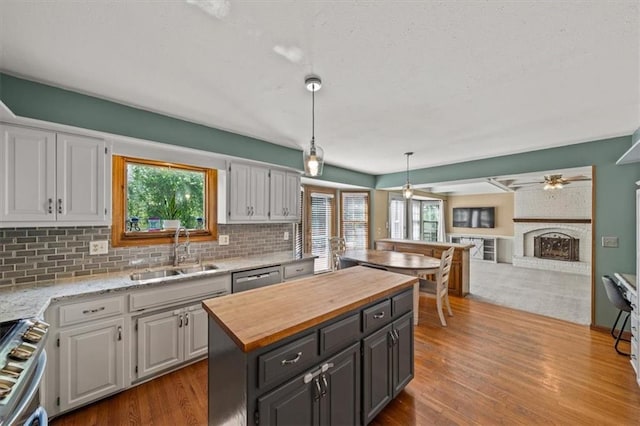 10601 Reeder St, Overland Park, KS 66214 - kitchen with wooden counters, stainless steel appliances, backsplash, a center island, and wood finished floors