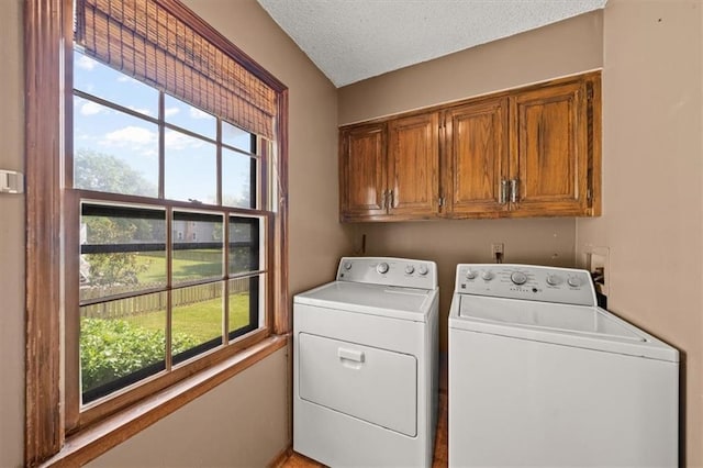 10601 Reeder St, Overland Park, KS 66214 - washroom with cabinet space, washer and dryer, and a textured ceiling