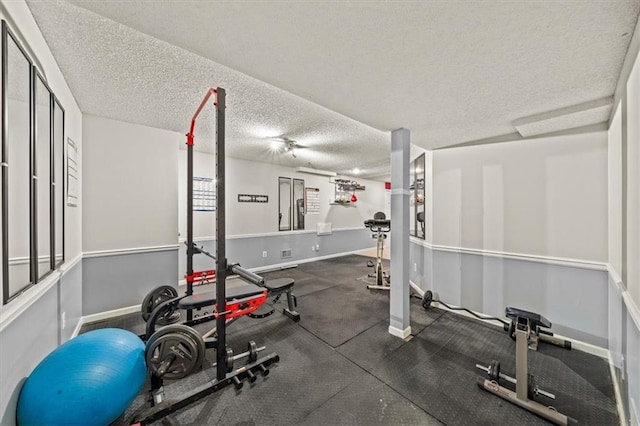 10601 Reeder St, Overland Park, KS 66214 - exercise area featuring a textured ceiling and baseboards