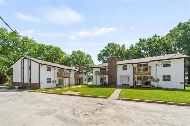 902 Twin Oaks Ter, Harrisonville, MO 64701 - multi unit property featuring a balcony, a chimney, a front yard, and brick siding