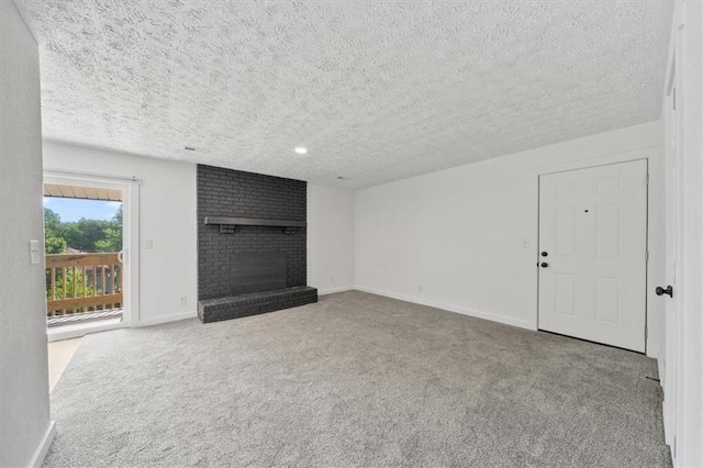 902 Twin Oaks Ter, Harrisonville, MO 64701 - unfurnished living room featuring a textured ceiling, a fireplace, and carpet flooring