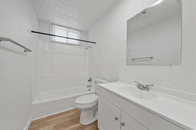 904 Twin Oaks Ter, Harrisonville, MO 64701 - bathroom with a textured ceiling, wood finished floors, vanity, bathing tub / shower combination, and a textured wall