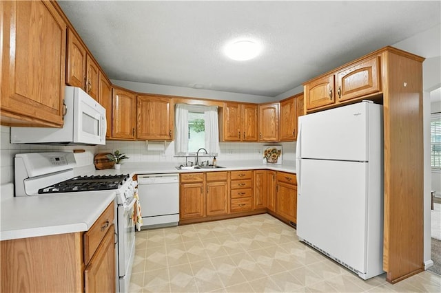 1303 SW Mission Pl, Lees Summit, MO 64081 - kitchen with white appliances, brown cabinetry, light countertops, backsplash, and a textured ceiling
