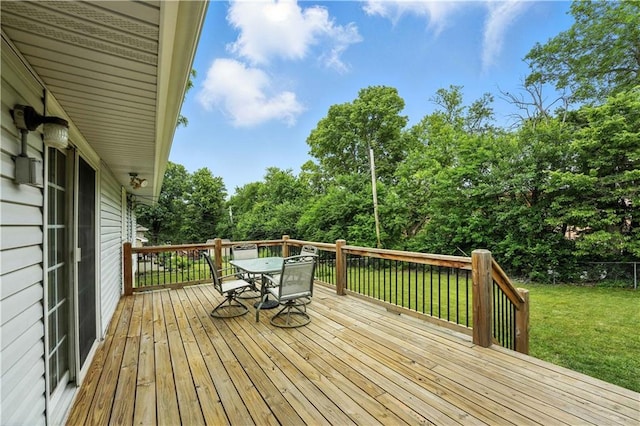 1303 SW Mission Pl, Lees Summit, MO 64081 - wooden terrace with outdoor dining space, a lawn, and view of scattered trees