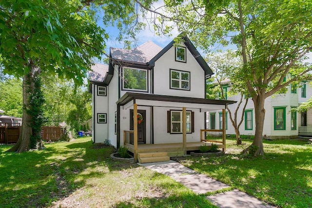 731 S Main St, Ottawa, KS 66067 - tudor house featuring a porch, stucco siding, and roof with shingles