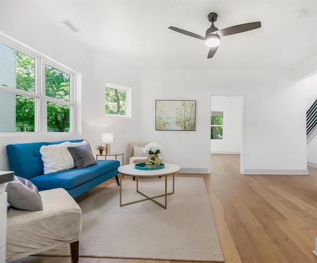 731 S Main St, Ottawa, KS 66067 - living room featuring light wood-style floors, plenty of natural light, and a ceiling fan