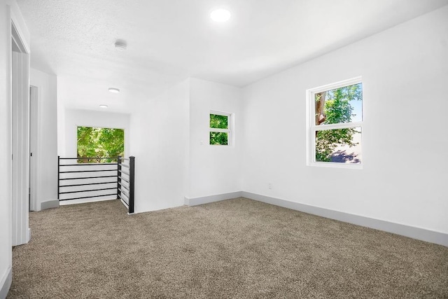 731 S Main St, Ottawa, KS 66067 - carpeted spare room featuring plenty of natural light and a smoke detector