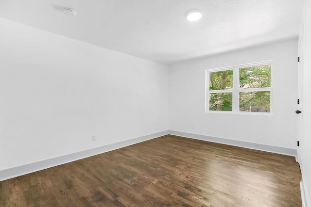 731 S Main St, Ottawa, KS 66067 - empty room with dark wood-type flooring, a smoke detector, and recessed lighting