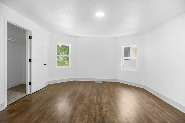 731 S Main St, Ottawa, KS 66067 - unfurnished bedroom featuring dark wood-style flooring and baseboards