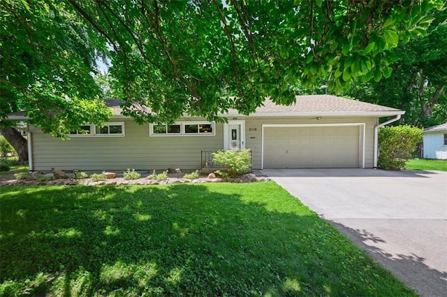 3118 10th Ave, Leavenworth, KS 66048 - ranch-style house featuring an attached garage, concrete driveway, and a front yard