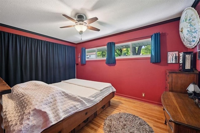 3118 10th Ave, Leavenworth, KS 66048 - bedroom featuring wood finished floors, a ceiling fan, crown molding, and a textured ceiling