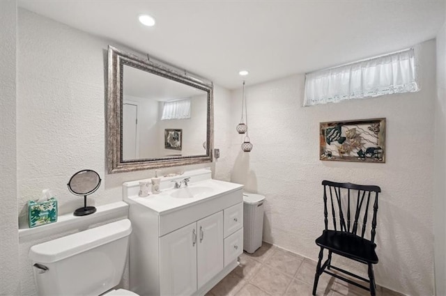 3118 10th Ave, Leavenworth, KS 66048 - bathroom featuring vanity, a textured wall, tile patterned flooring, and recessed lighting